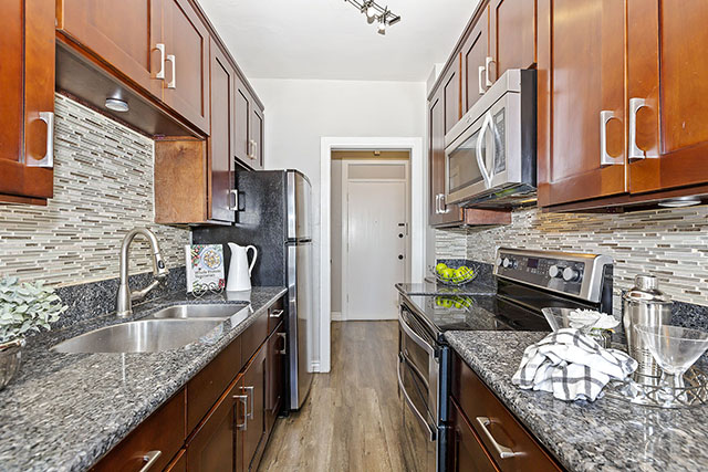 Galley-style kitchen with granite counter tops - Gallery Preview