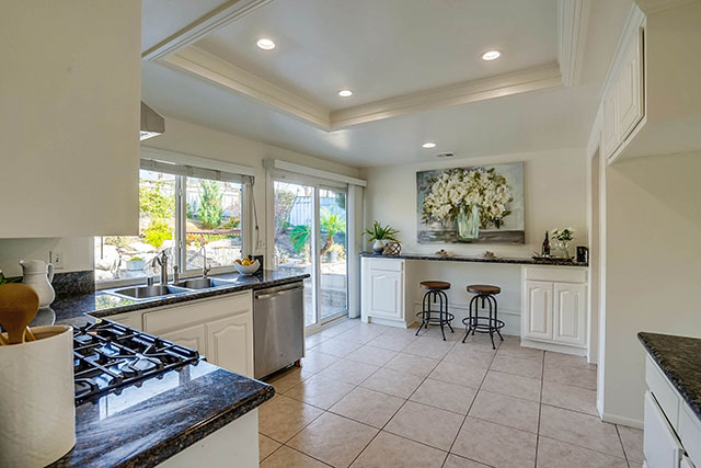 Kitchen with Granite Countertops, Stainless Steel Appliances, and Custom Breakfast Bar